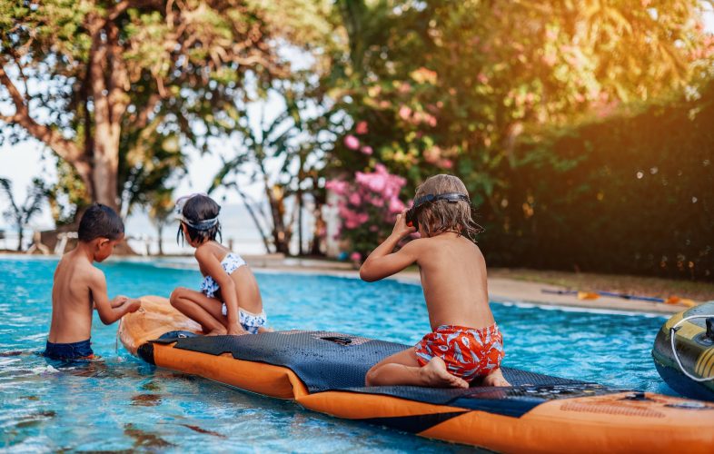 relaxed-children-swim-in-pool-together-with-boat-in-hotel.jpg